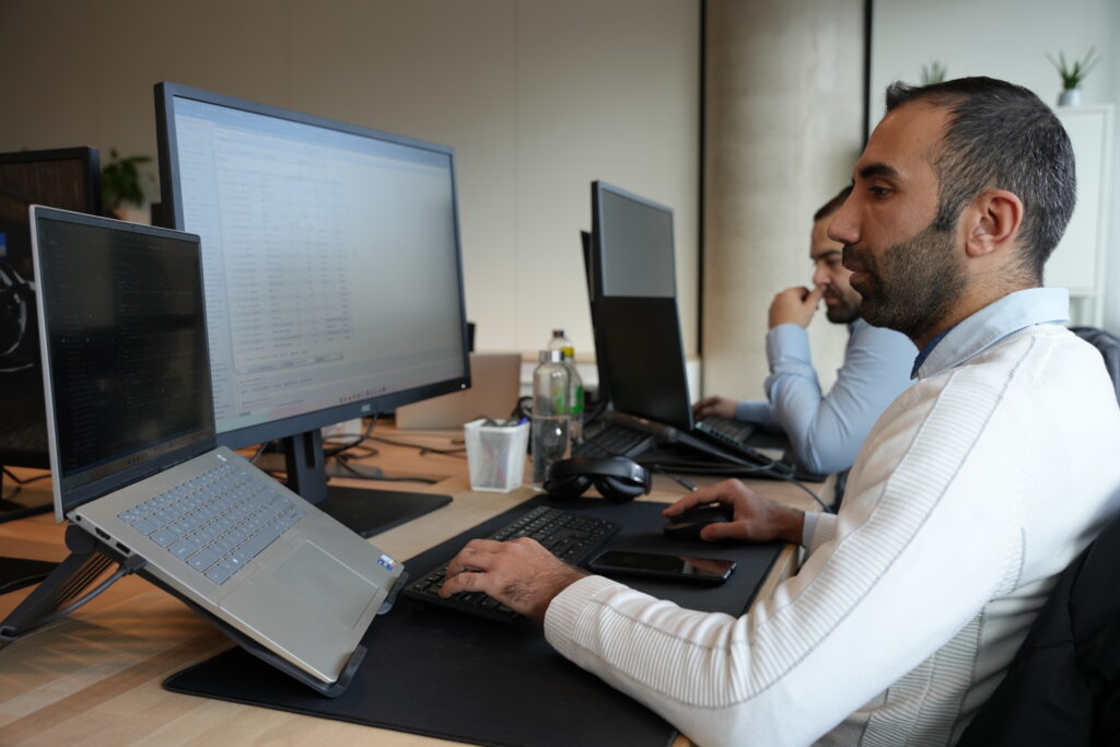 Custom application development for startups - iterates Developers working on a custom web application in a modern office.