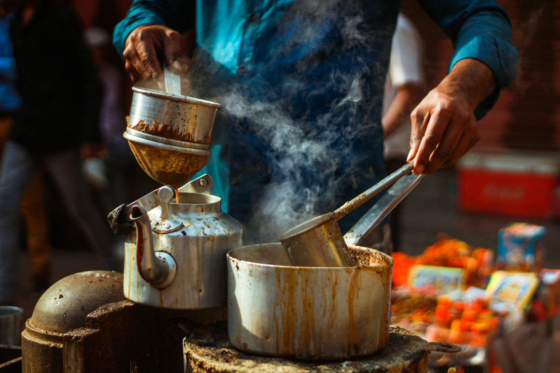 Traditional preparation of chai in the street - iterates Chai (Indian tea) vendor preparing the drink in the street.